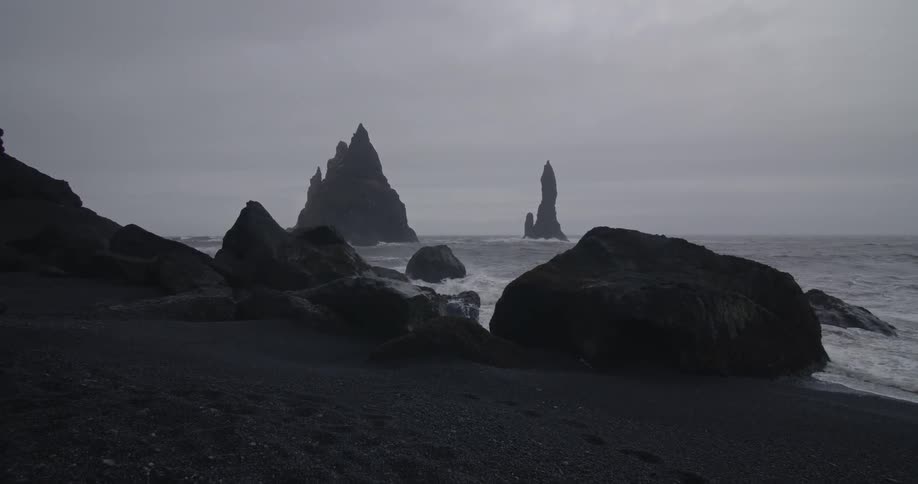 Waves washing up on a rocky beach on cloudy evening