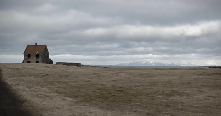 A desolate house sits in an empty field
