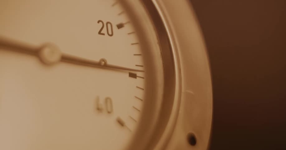A white clock with numbers and the hand is moving quickly