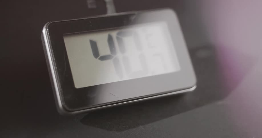 A glass object with a metaledged divider and a number inside that is going up