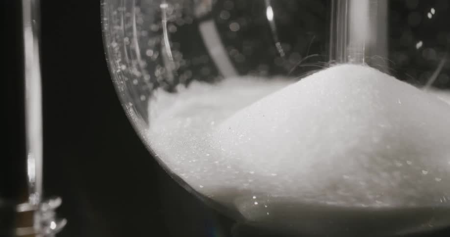 Close up of an hour glass filling with sand