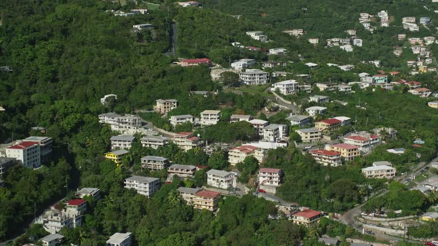 A hill covered in both buildings and vegetation