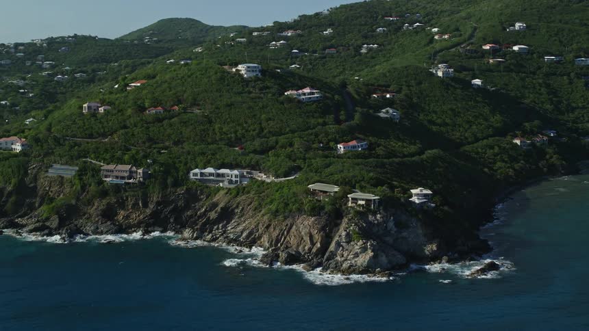 Aerial view of houses on the slopes of the mountains on an island