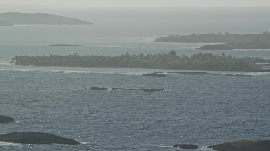 Aerial view islets in choppy ocean during the day