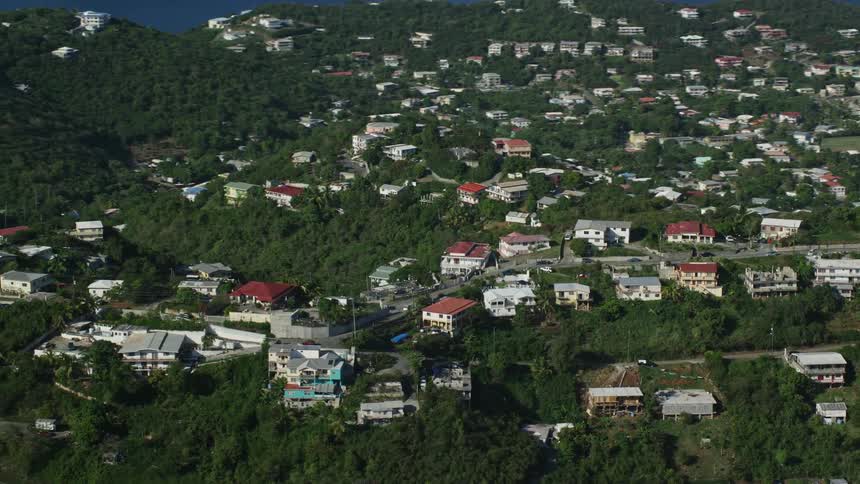 An island covered in equal area by houses and vegetation
