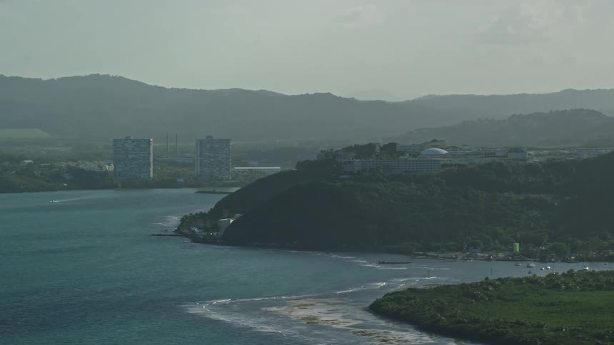 Aerial panorama of a blue beach next to hotels and sea coast