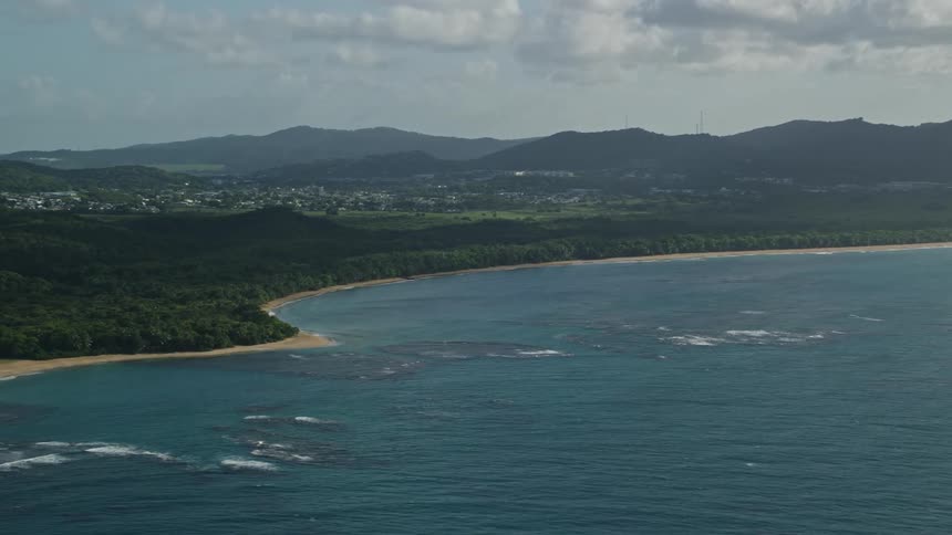 Aerial view blue ocean sandy coastline and green rolling hills