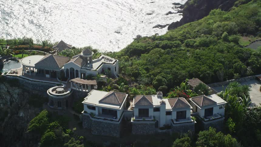 Aerial panorama of a huge mansion on a hill by the sea