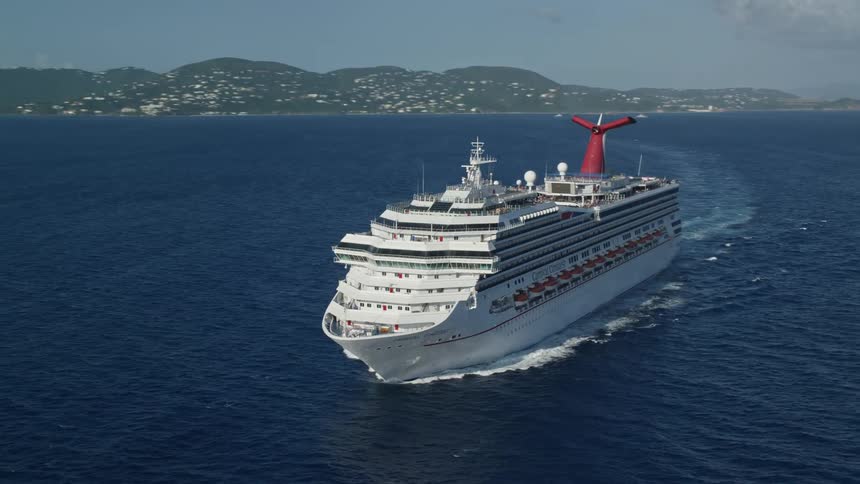 A cruise ship traveling across the ocean during a sunny day