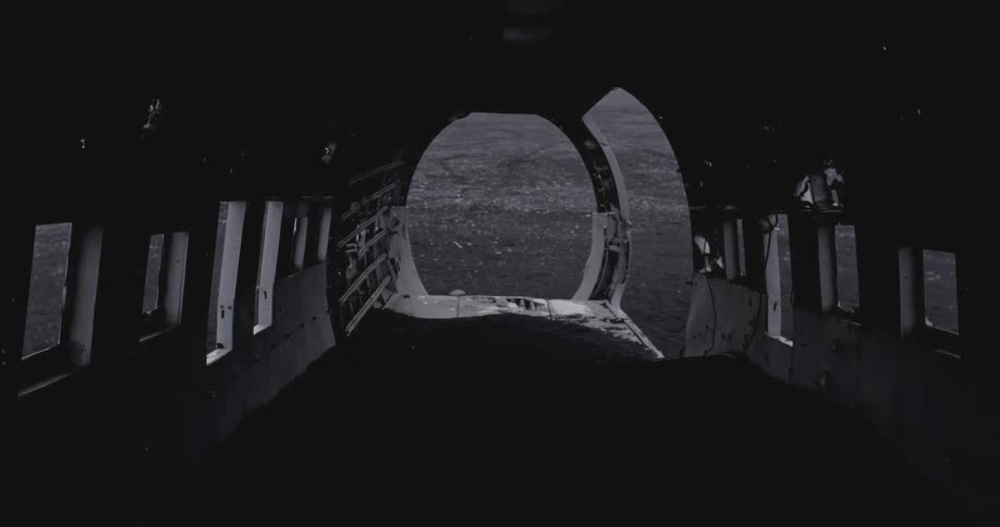 A downed airplane has some light shining in the cabin ahead