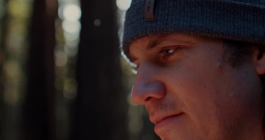 Closeup of a smiling mans face in the forest