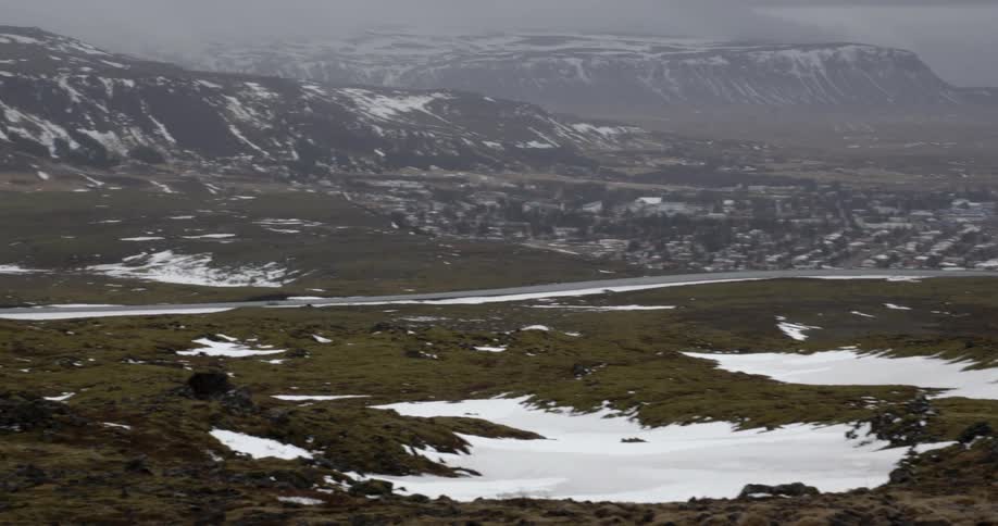 Patches of snow cover a field