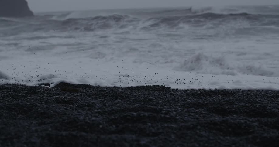 Foamy waves wash onto a rocky shore