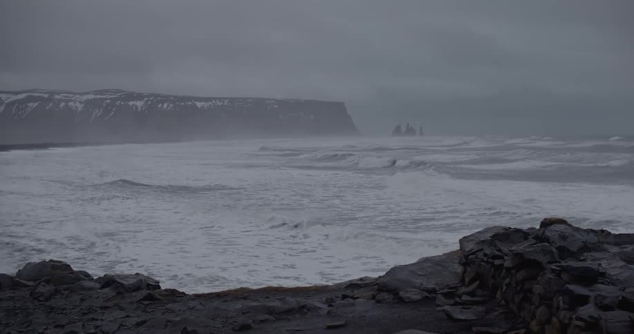 White, frothy waves rolling ashore on a foggy day