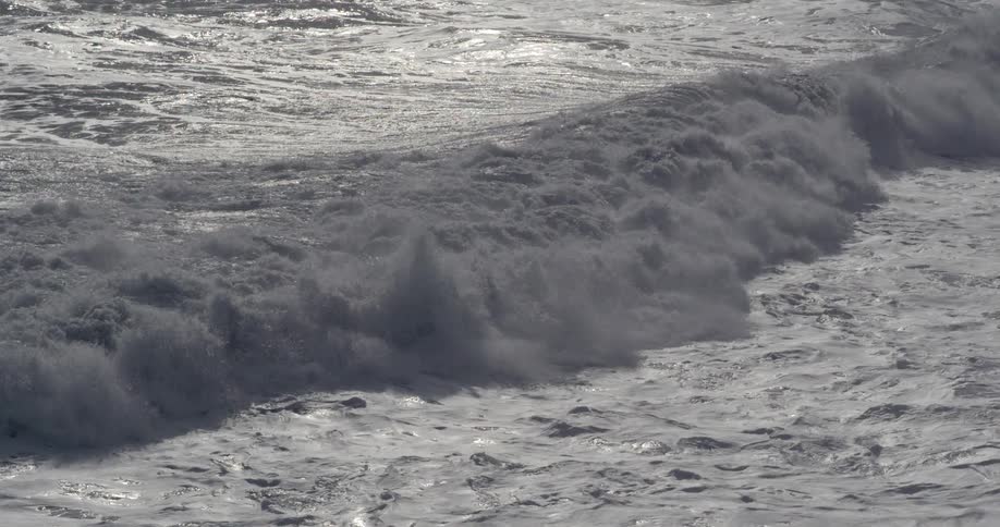 Waves move along the coast on a sunny day