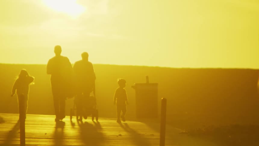 A family walking out on a pier outdoors