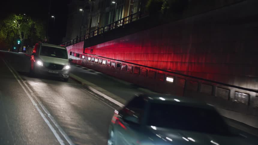 A busy street at night in a neighborhood