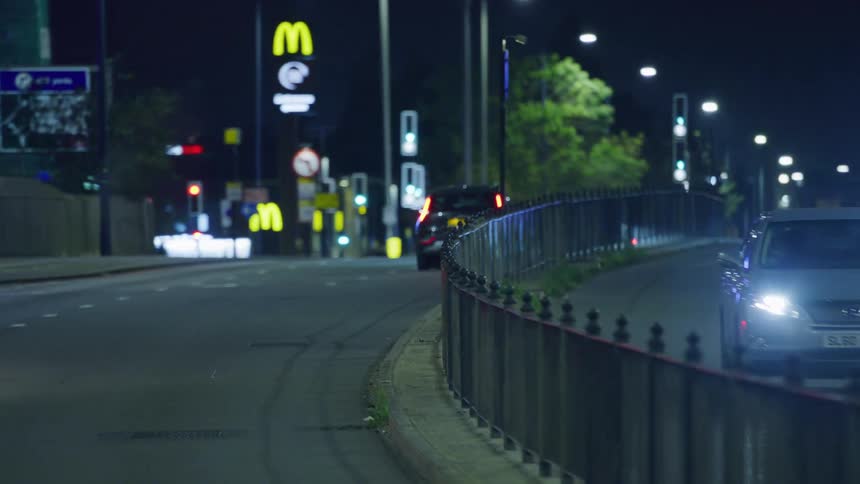 Cars drive down a city road