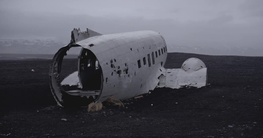 The wreckage of an old airplane on a cloudy day