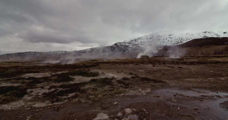 Steam rises off a rocky terrain on a cold and overcast day