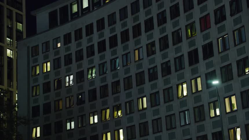 A large curved office building at night