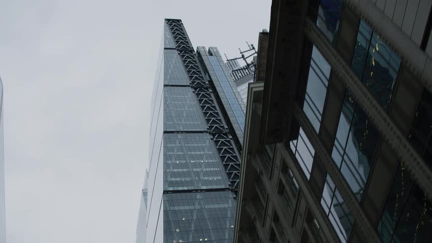 An allglass skyscraper in the urban city