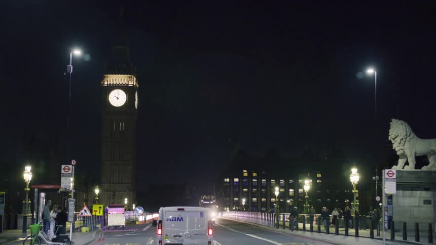 Vehicle driving on the highway with big ben in the background at night