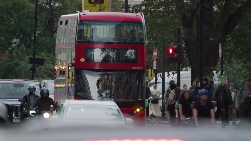 A tourist bus on a busy street in the city of london