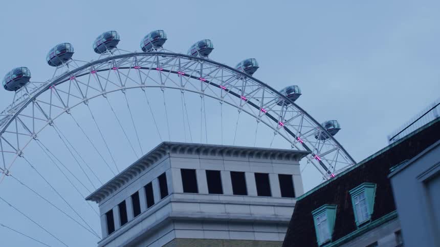 View of buildings with a static ferris wheel in the background