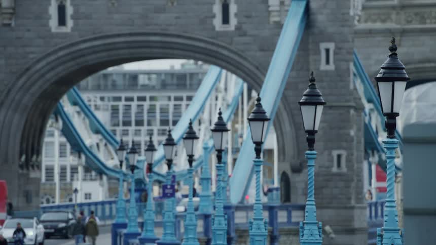 People walking on a street with a blue lamppost in the city