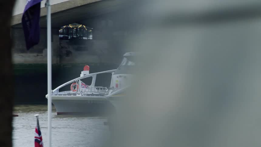 View of a boat with a passenger passing under a bridge