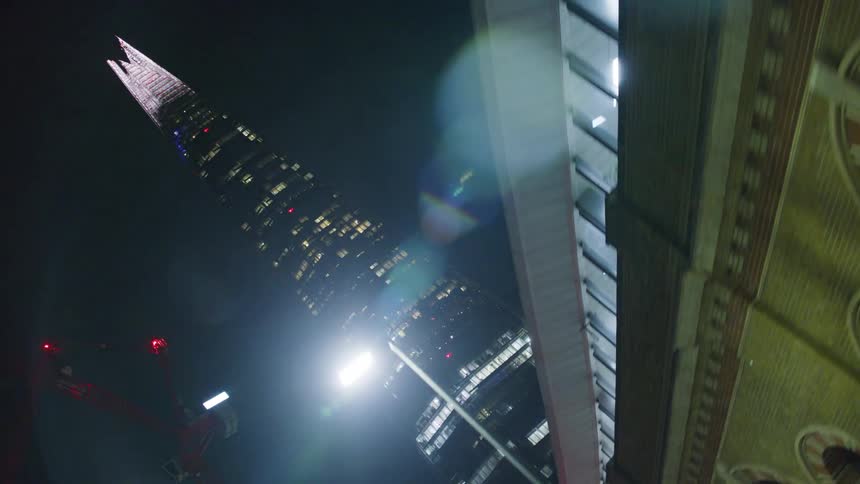 Panorama of a metropolis at night with a view of a tower on a pointed building