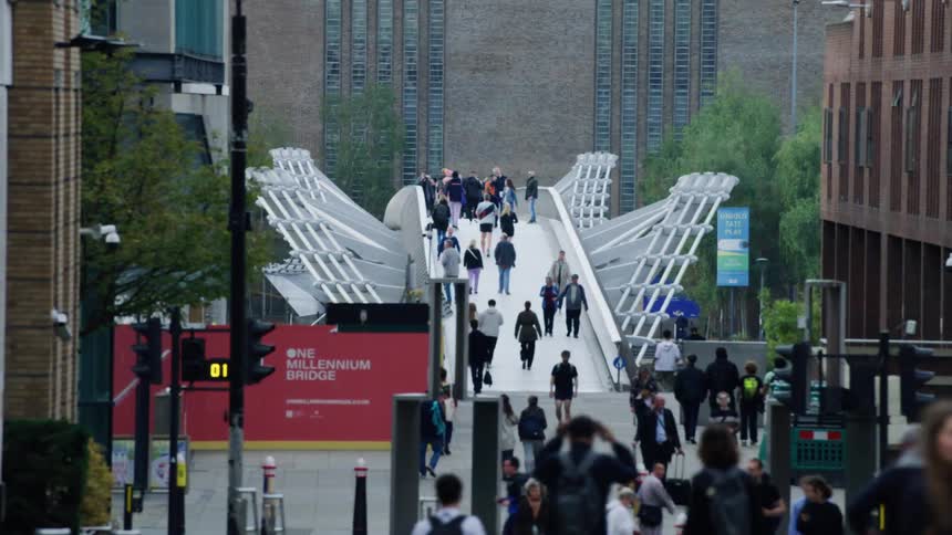Pedestrians walking along a footbridge in the city