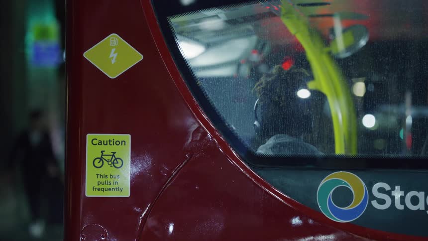The back of a london red bus before it starts moving