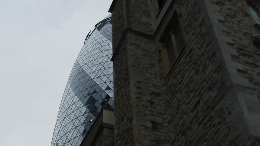 Upward view of the dome of a modern rounded mirrored building