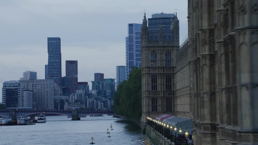 London buildings near waterfront bridge during the day