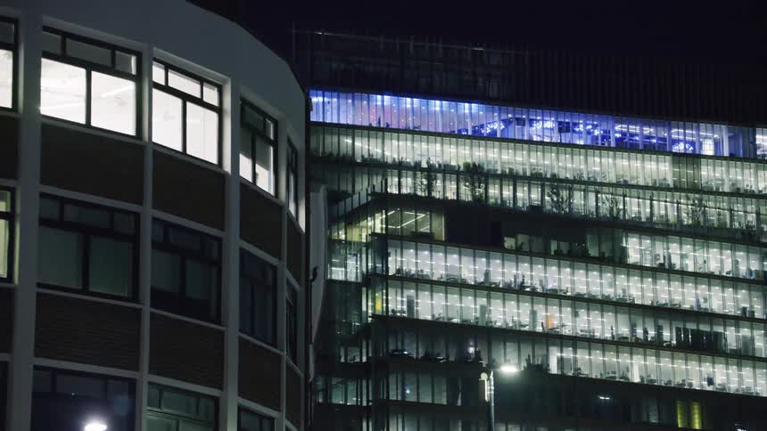 Night view of large buildings in a metropolis illuminated