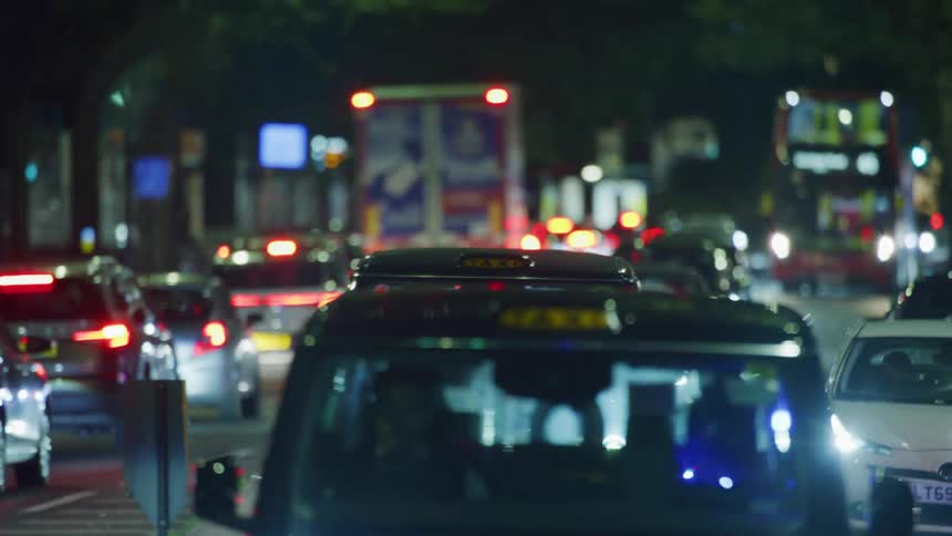 Cars carefully navigate a busy city street
