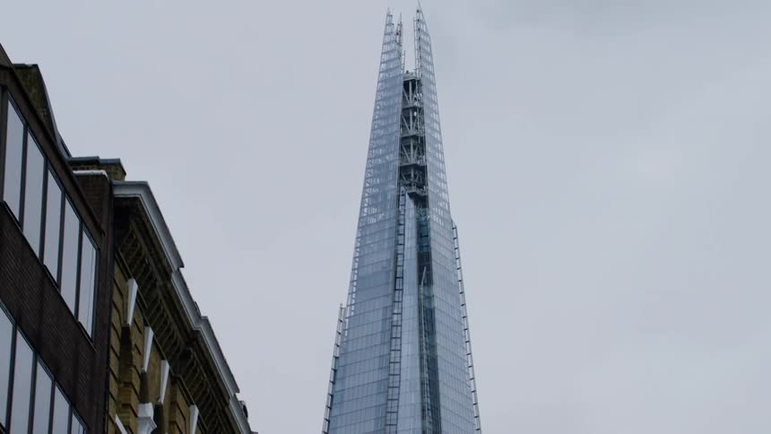 Upward view of a modern skyscraper all mirrored on a cloudy day