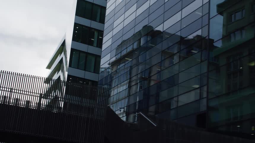 Architecture of a mirrored commercial building on a cloudy day
