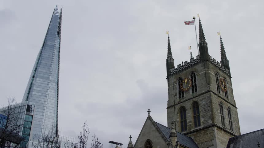 A skyscraper sits near an old church