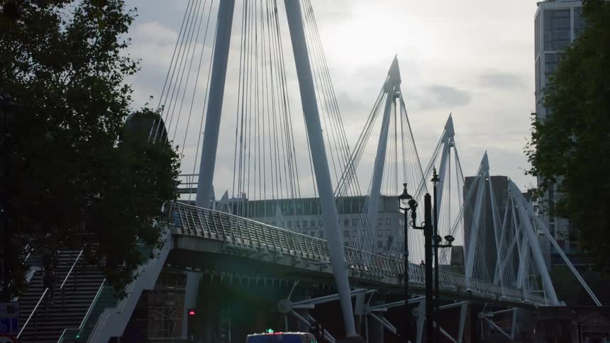 Street in a metropolis with traffic and a bridge beside it