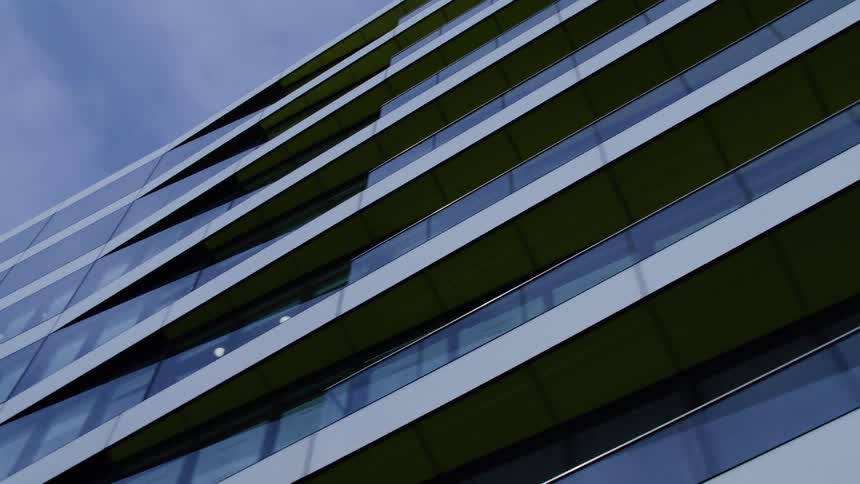 A modern building with horizontal lines and reflective surfaces