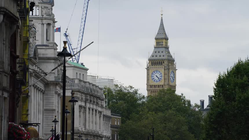Big ben clock tower and downtown london street level view on a cloudy day