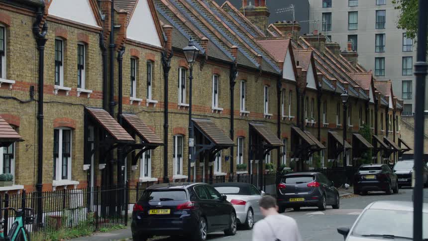 A man walks through a neighborhood of private residences