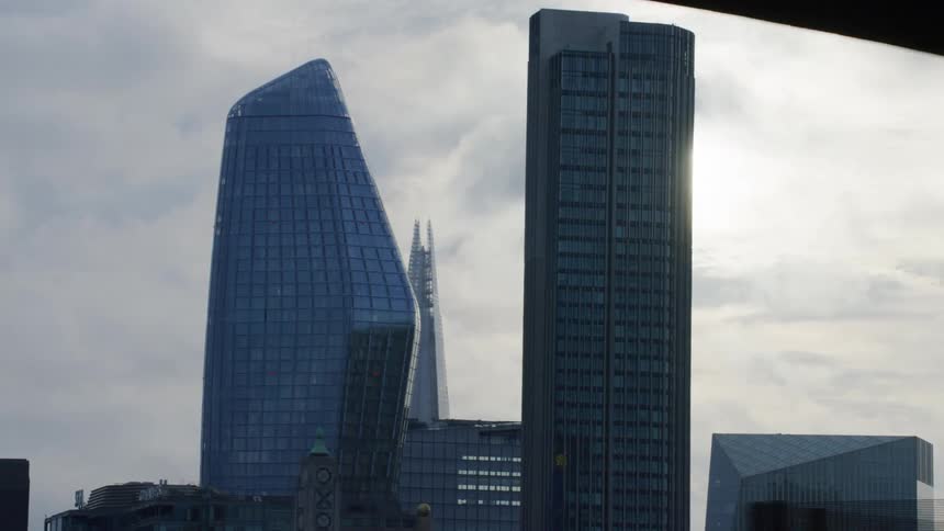 View of two huge mirrored buildings on a cloudy day