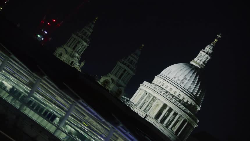 A night view of st pauls cathedral in london with the city lights at night