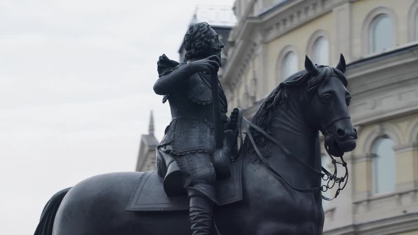 A statue of a man on a horse is in the city