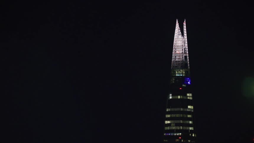 The shard london at night plane flies by