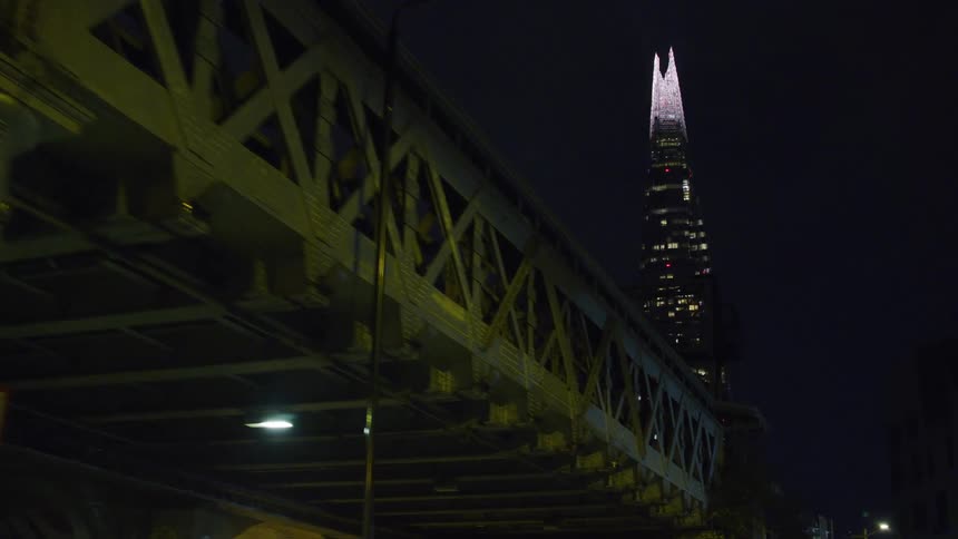 A bridge sits in front of a skyscraper